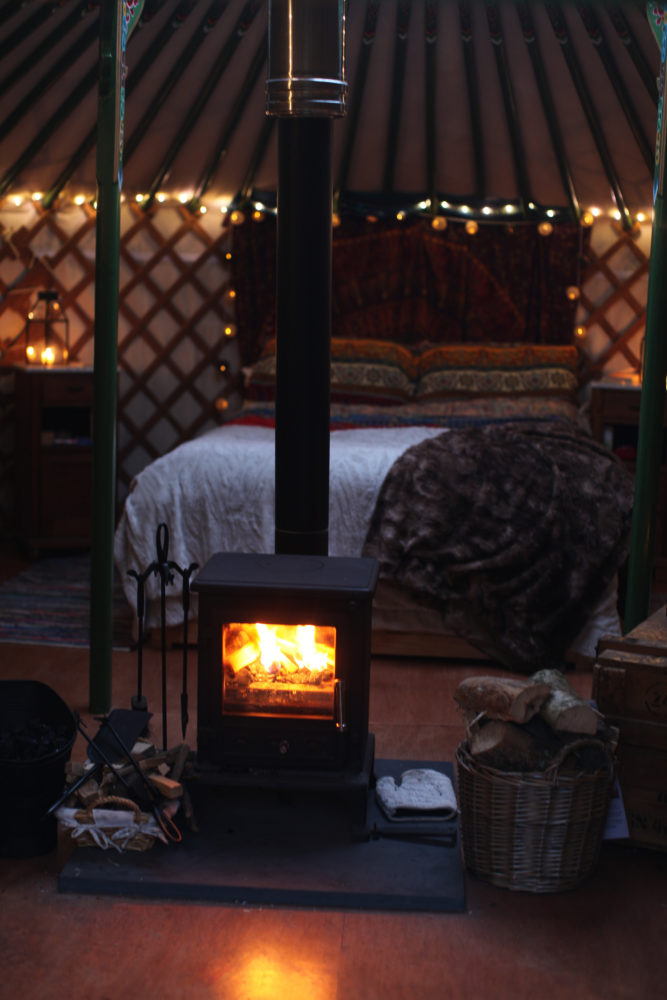 yurt, glamping, fire, log burner, stive, warm, cosy, snug, bed, fairy lights, fairylights, wood, basket, lanterns, candles, winter break, winter holiday, weekend break, unique retreat, winter glamping, magic, magical